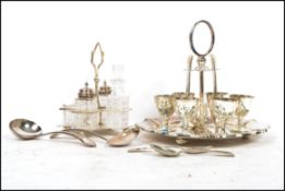 A group of silver plated wares to include a six person egg breakfast set with scalloped base,