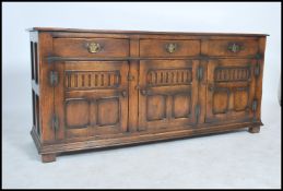 An exceptional Ipswich oak Jacobean revival dresser base sideboard having carved doors with short