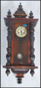 A 19th century walnut cased vienna regulator wall clock with decorative case drop pendulum and
