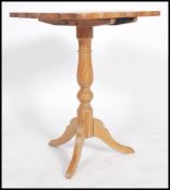 A Victorian country pine tilt top wine table raised on splayed legs with turned legs and rectangular