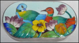 A vintage Russian silver large pill box of oval form having a beautifully enamelled lid decorated