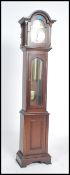 A Tempus Fugit grandmother clock with mahogany case and hood having inset brass and silvered dial