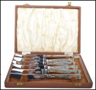 A set of 6 20th century cased silver hallmarked handled knives complete in the presentation case