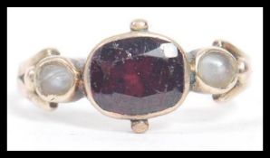 A believed 14ct gold 20th century ladies ring adorned with central amethyst flanked by clear stones.