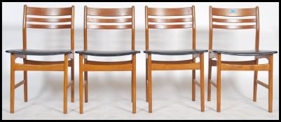 A set of 4 Danish ladder back dining chairs with black leather seat pads and teak frames with stamps