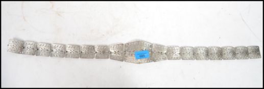 A silver plated Victorian nurses belt having a pierced geometric pattern, each link and piece