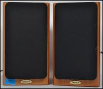 A pair of contemporary unused wall mountable speakers by Tannoy retaining packaging.
