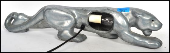 A vintage 20th century silver chrome table lamp in the form of a pouncing jaguar with bulb to side.
