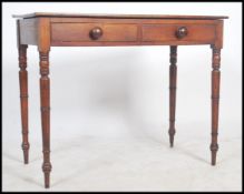 A Victorian mahogany writing table desk being raised on well proportioned ring turned tapering