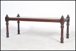 A 19th century Victorian mahogany coffee table raised on turned column supports surmounted with bell