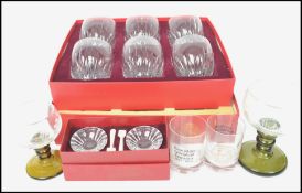 A boxed set of Baccarat crystal glass whisky tumblers together with a boxed pair of Baccarat crystal