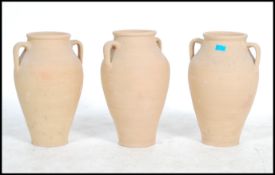A collection of 3 20th century studio pottery large floor standing pottery terracotta amphora.
