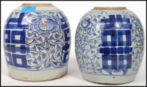 A pair of Chinese bulbous squat bodied blue and white ceramic ginger jars of larger proportions.