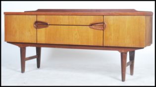 A 1970's gallery backed teak sideboard having two unusual recessed ovoid shapes which make up the