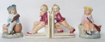A pair of Victorian ceramic novelty bookends having children pushing and pulling along with a pair