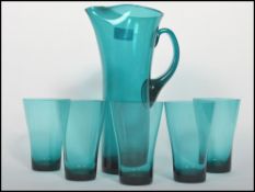 A stunning hand made retro lemonade set in a turquoise glass consisting of a tall lemonade jug