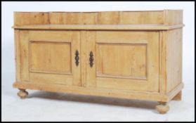 An early 20th century French pine window seat bench / settle. The pine base with twin doors having
