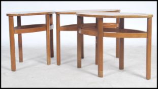 A set of 3 teak wood Nathan lozenge shaped tables, each raised on squared legs united by stretchers