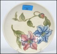 A mid century Walter Moorcroft ceramic bowl of open form being tube lined and painted with flowers