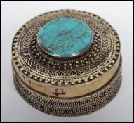 A vintage Kazakhstan silver gilt and Turquoise snuff box from Russian central Asia of circular form,