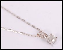 A good 18ct white gold and diamond pendant and cha