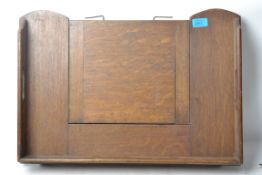 A 1930's Edwardian oak metamorphic bed tray / lectern having drop down fold out legs.