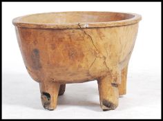 A stunning large continental ( possibly Eastern European origin ) wooden dough bowl raised on four