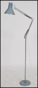 A vintage 20th century retro industrial Danish anglepoise standard lamp raised on a circular grey