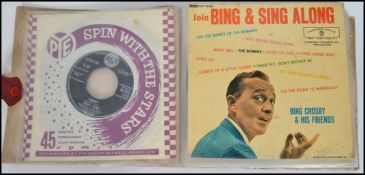 A collection of vintage 45 rpm records in carry sleeve to include Elvis Presley on RCA VIctor, RCA
