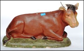 A vintage retro 20th century advertising point of sale agricultural model of a cow moulded in a