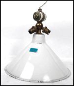 A vintage 20th century retro industrial enamel pendant light fitting having a set of brass