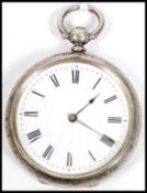 A silver hallmarked chase decorated open faced pocket watch, Roman numeral chapter ring on enamel