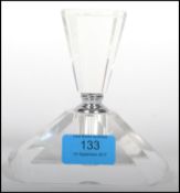 A vintage 20th century art deco cut glass perfume bottle of faceted angular form with twist top