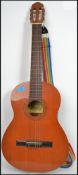 A Raimundo acoustic six string guitar model 106 having a shaped hollow body with makers name to