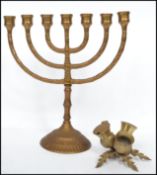 A cast metal ormolu Menorah together with a late 19th / early 20th century brass table three piece