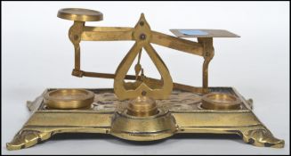 A set of late 19th century brass and wooden base postal pan scales, together with a small