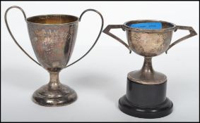 A silver hallmarked trophy / cup bearing the inscription Wing Nam Cup together with another silver