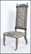 A 19th century Victorian prie dieu praying / nursing chair raised on turned and splayed legs with