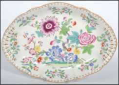 A 19th century ceramic Chinoiserie scalloped dish believed to be by Mason's, heavily decorated