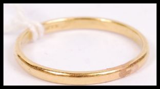 An 22ct hallmarked ( worn marks tested ) gold ring of usual simple form. Weighs 2.2g size P.5