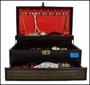 A collection of costume jewellery within a good black tooled leather jewellery box to incluce
