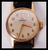 A vintage ladies 9ct gold Omega dress watch having 21 jewel movement set within. Set to a black