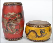 A pair of Chinese drums having animal skin to top