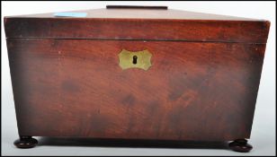 A 19th century Regency rosewood caddy box. Of large form with hinged sarcophagus top over open
