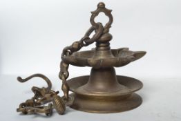 An unusual heavy cast brass Chinese swinging incense burner. Of roundel form with multiple incense