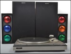 A vintage JVC LA55 vinyl record turntable along with a pair of disco traffic lights and a pair of