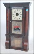 A large 19th century American Gingerbread clock with a rectangular walnut upright gase having