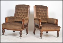 A good pair of Victorian oak gallery back ladies and gents armchairs  being raised on turned legs