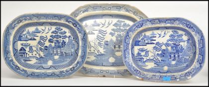 A collection of 3 blue and white willow pattern meat platters to include Staffordshire Stone Ware