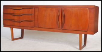 A superb vintage mid century teak wood sideboard, fitted three drawers to the left with double